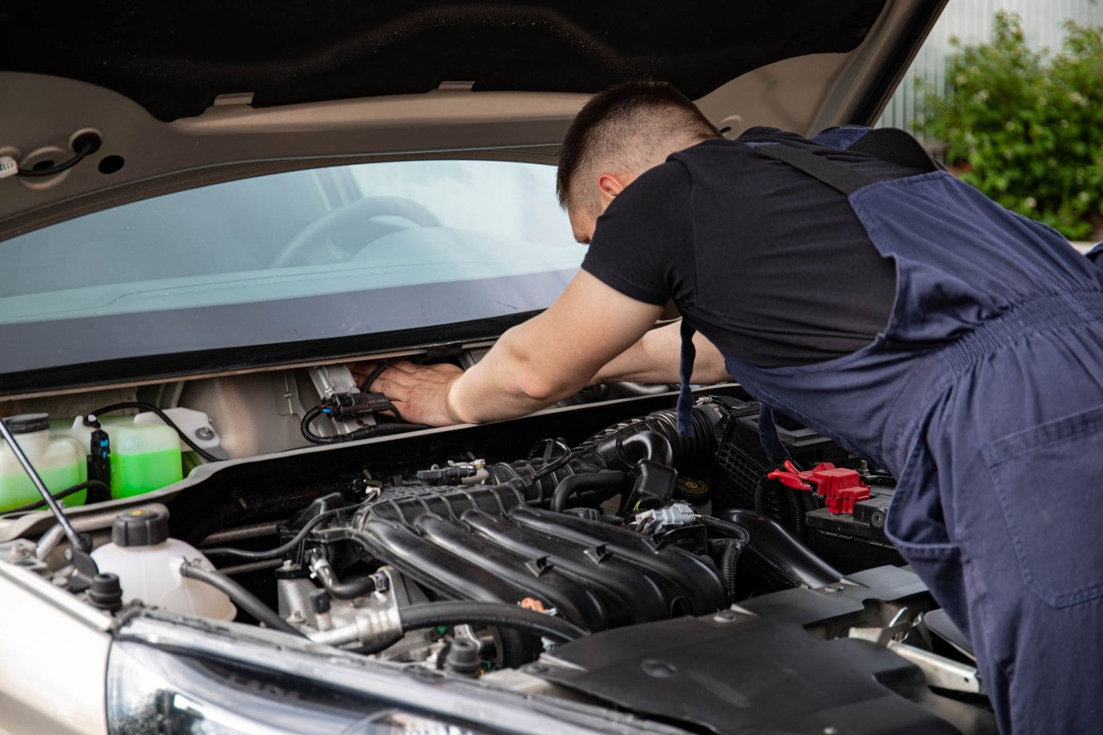 Mechanic inspecting the engine bay of a Nissan diesel for AdBlue system fault